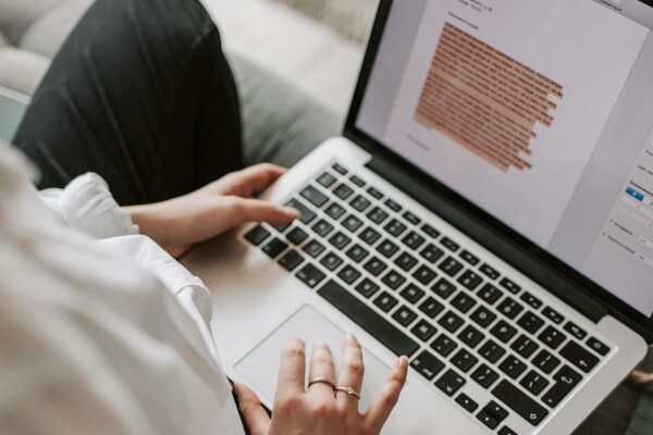 Women sitting at a computer editing a text document