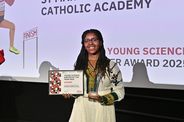 The winner of the 2025 Young Science Writer Award with her certificate and award while wearing traditional Ethiopian dress.