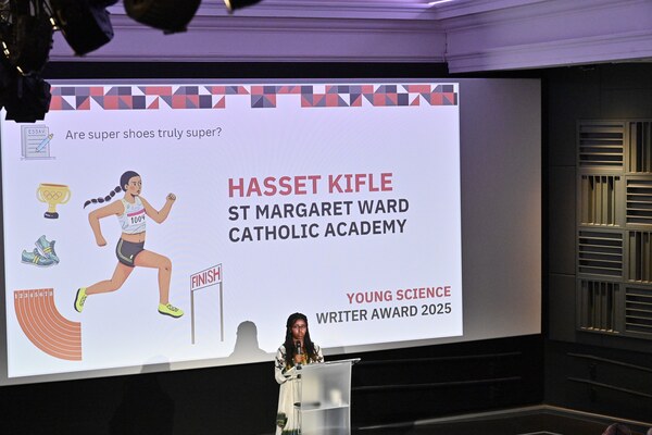 The 2025 winner reading her essay on stage at the Science Museum