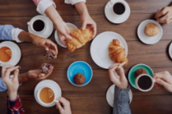 aeriel view of hands and coffee cups at a table