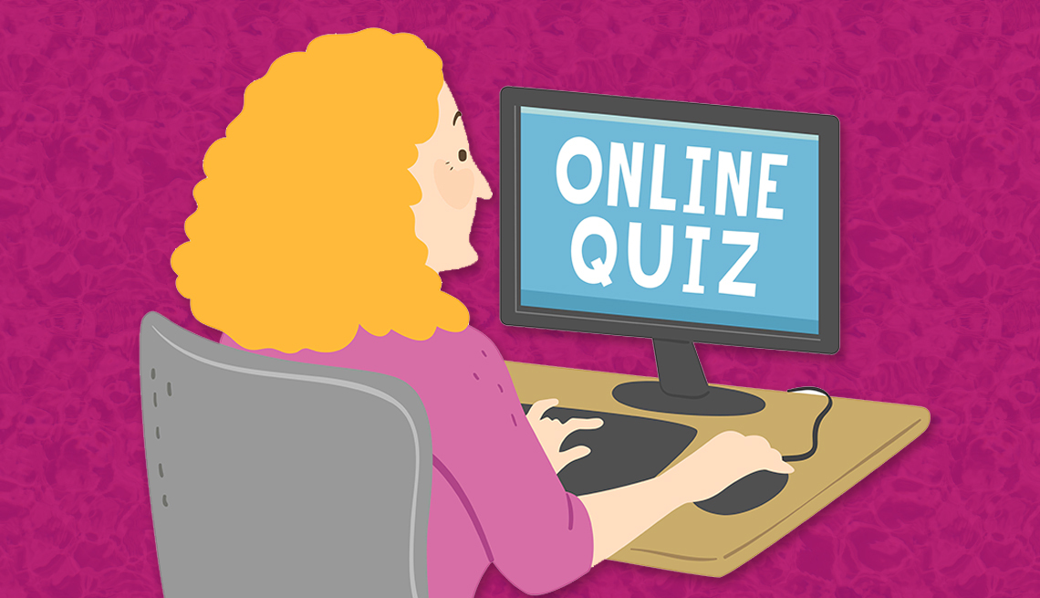 A woman sat at her computer ready to play the Online Quiz