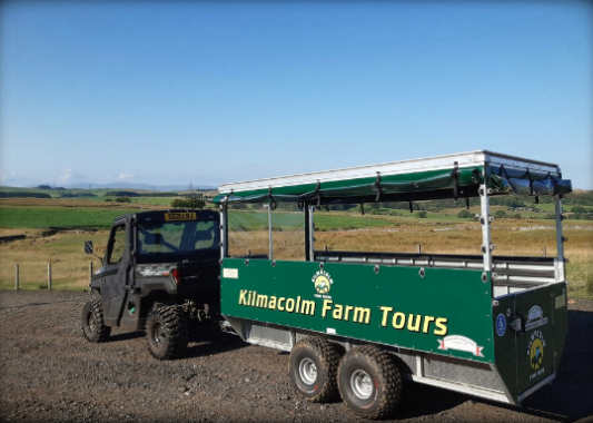 Picture of a buggy and trailer with Kilmacolm Farm Tours written on the side