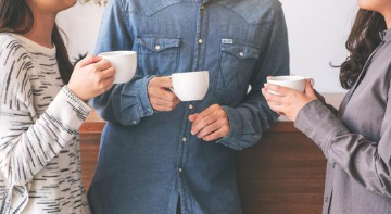 people standing holding mugs