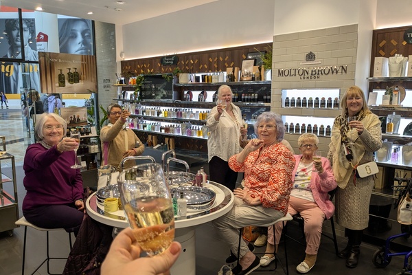 Ladies toasting in a lovely fragrance shop