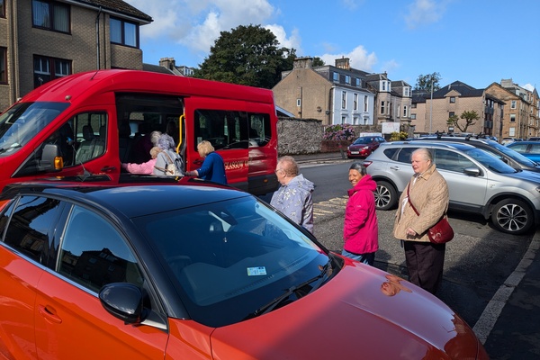 sunny day and people getting on a bus