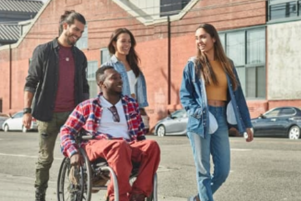 wheelchair user and people enjoying a walk together