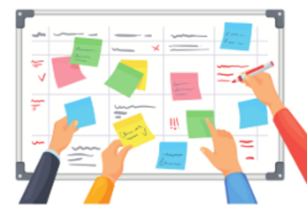 wallplanner with hands sticking post it notes on