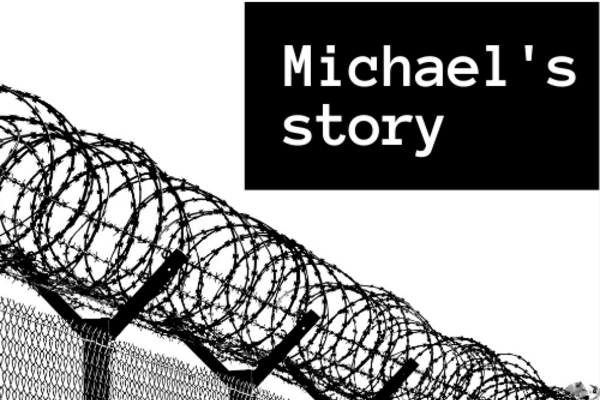greyscale image of circular barbed wire and fence with a black box in the top right corner that reads 'Michael's story'