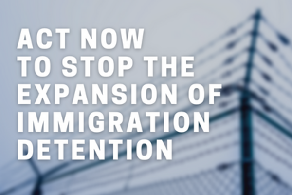 blurred image of a barbed wire fence in the background. In the foreground there is white text in capital letters which says 'act now to stop the expansion of immigration detention'