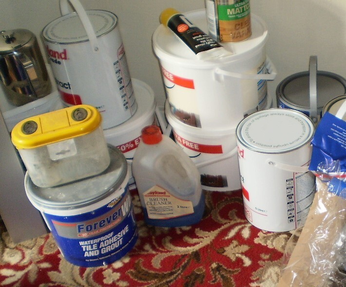 Painting supplies piled up on the floor.