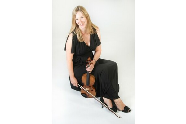 Karina MacAlpine seated with her violin