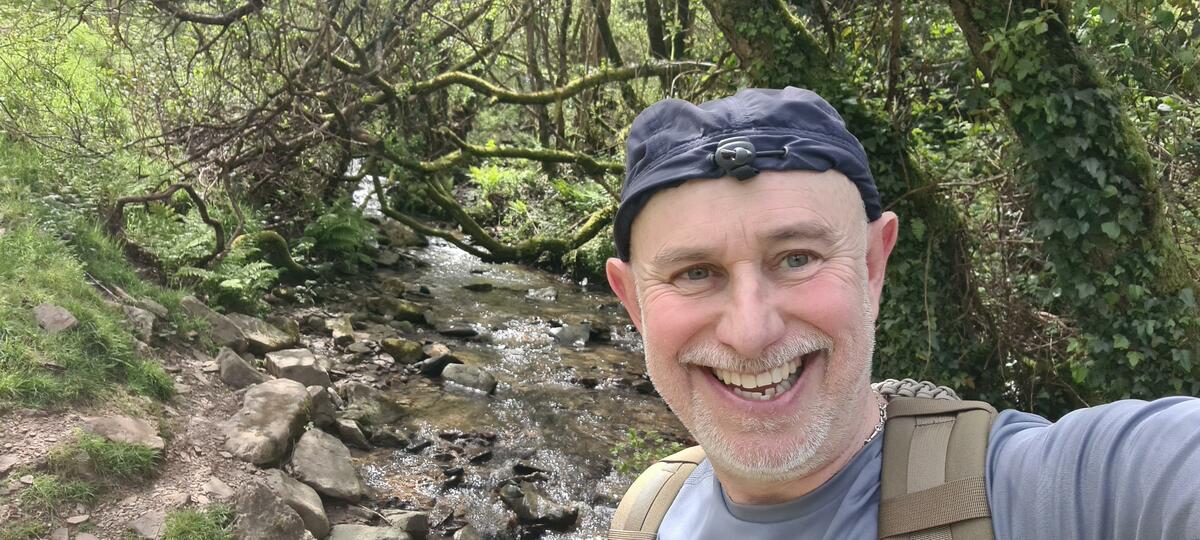 Paul Kiernan smiles with a stream behind him