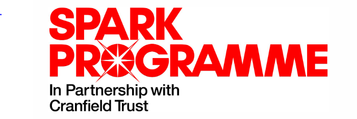 Spark Programme logo, Spark Programme written in red with the words' In partnership with Cranfield Trust' written in black underneath