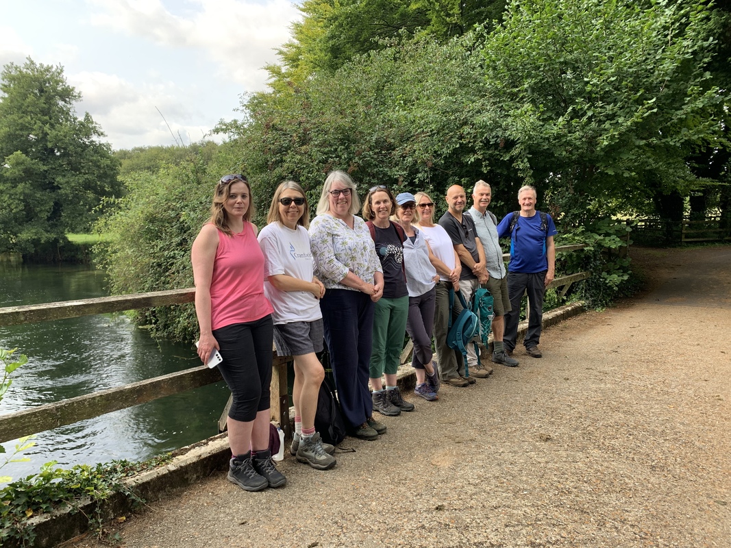 Photo of nine people in a line in the countryside, they people includes Amanda Tincknell Cranfield Trust CEO and staff