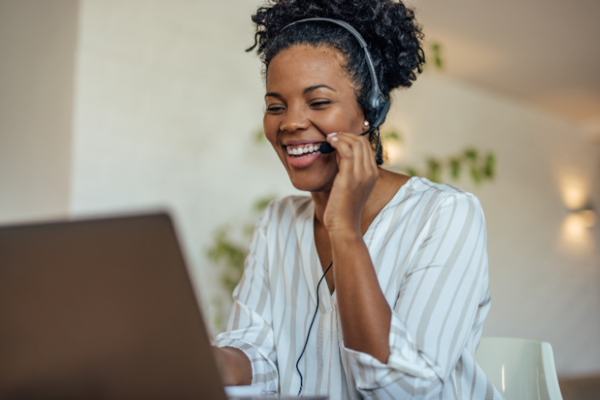 A black woman wearing a telephone headset