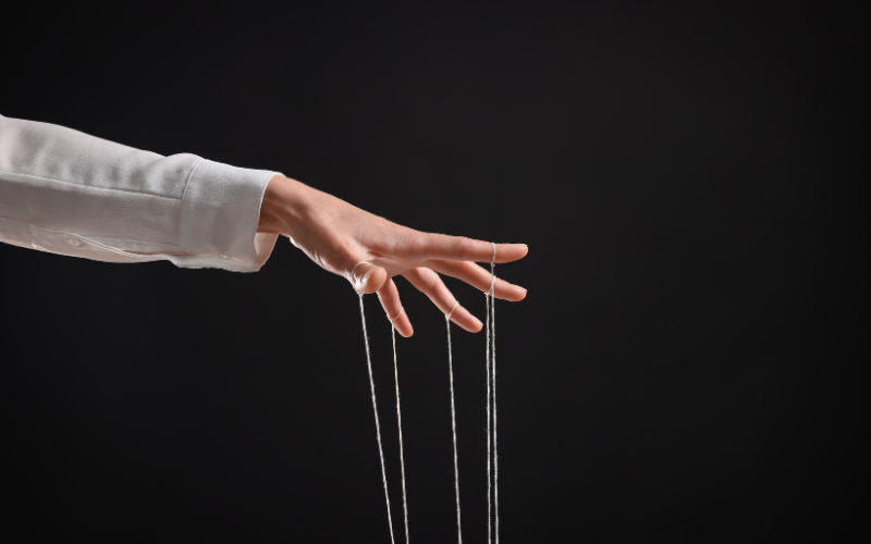 A hand with strings pulling from it
