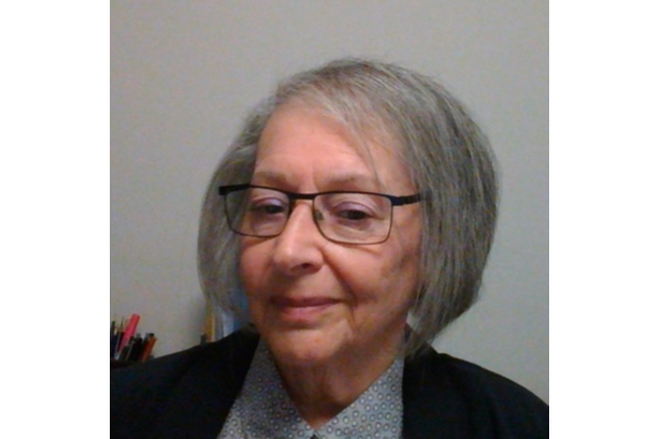 Photo of Sue Davidson, a lady wearing glasses with grey hair in a bob, Sue is smiling