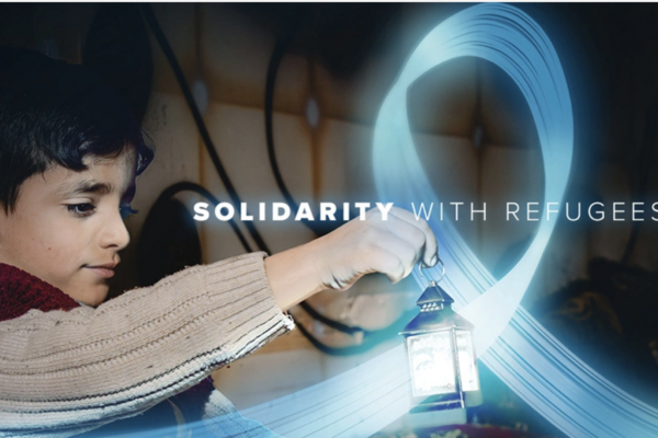 Image of a young refugee child with a lamp