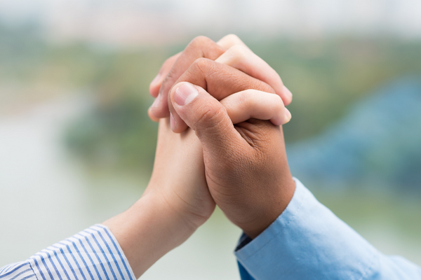 two hands clasped together