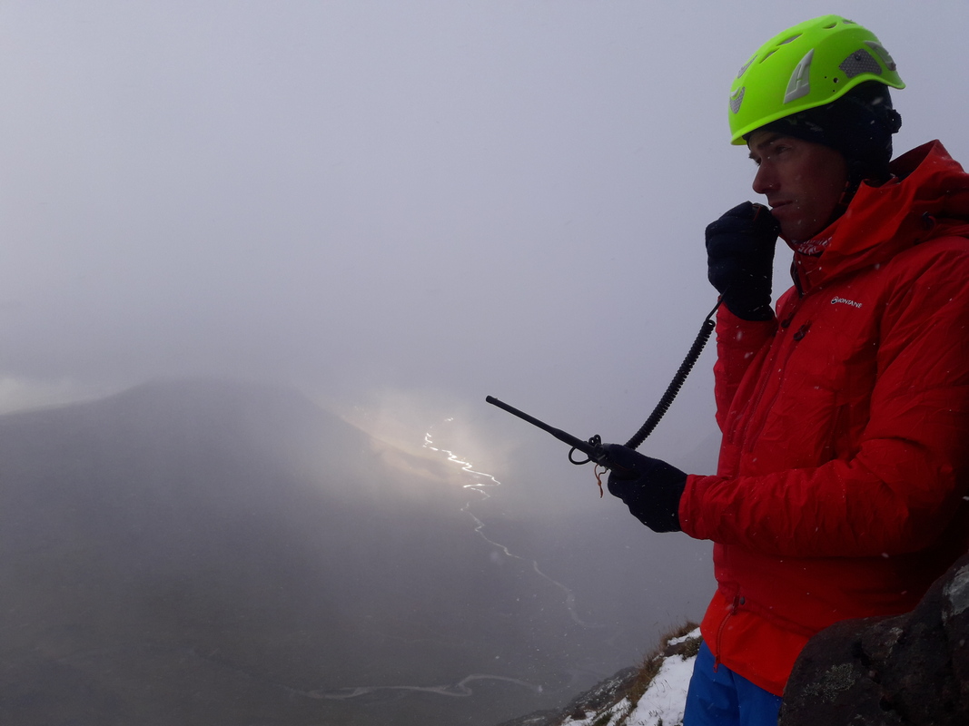 Mountain rescue team member talking on radio