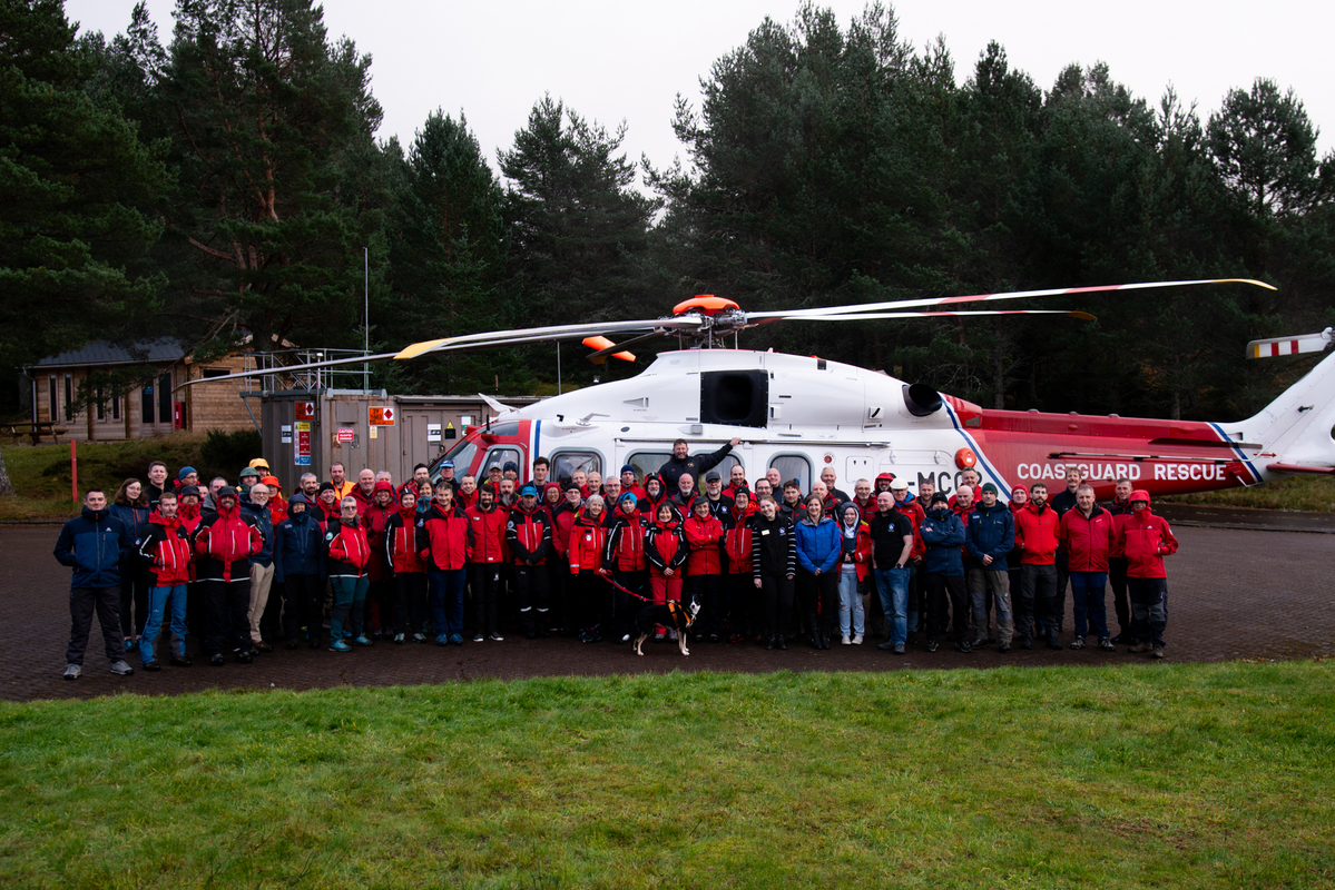 Scottish Mountain Rescue teams gathered around helicopter