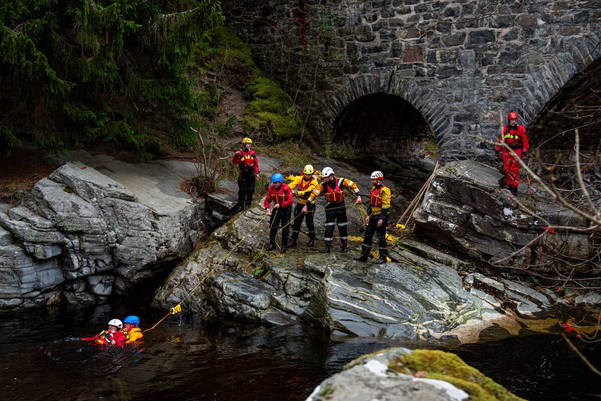 Mountain rescue team working in river
