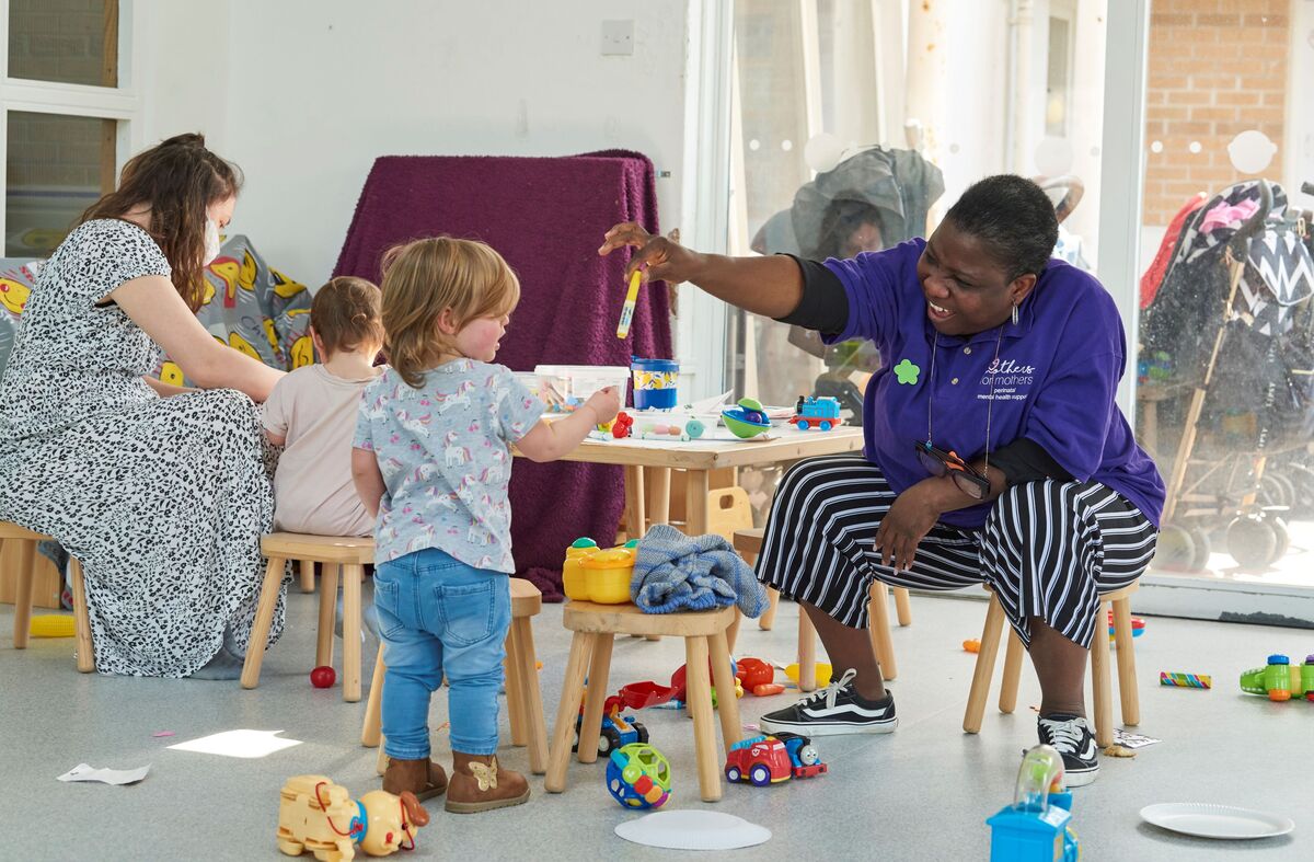 Mothers For Mothers staff member playing with child