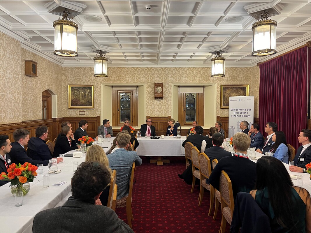 Guests follow the panel discussion at the 2025 Real Estate Finance Forum in the Attlee and Reid Room of the House of Lords.