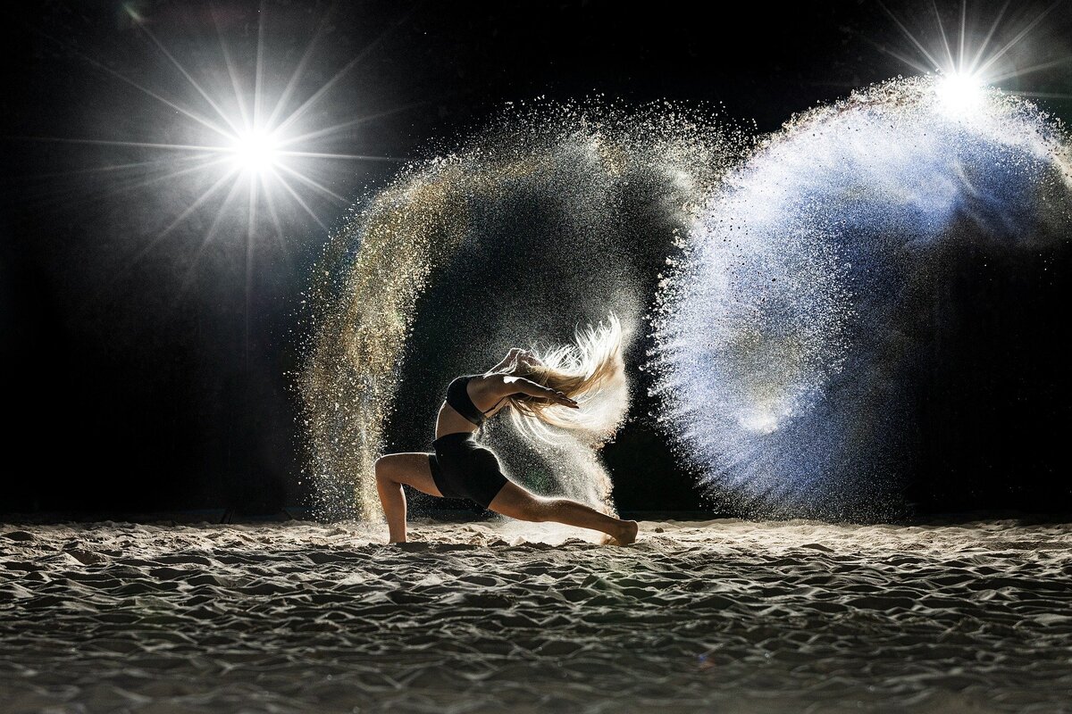 Dancer on stage flicker her hair with bright lights