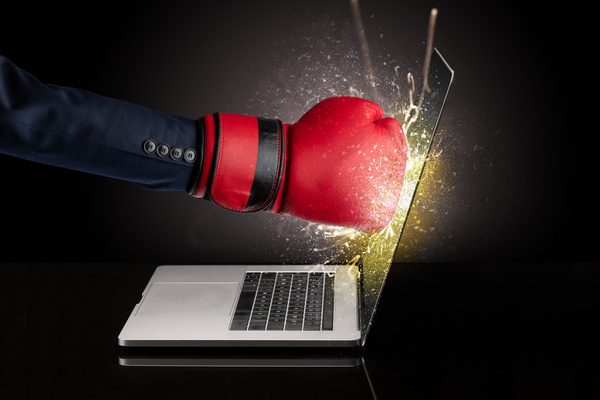 Boxing glove punching laptop screen