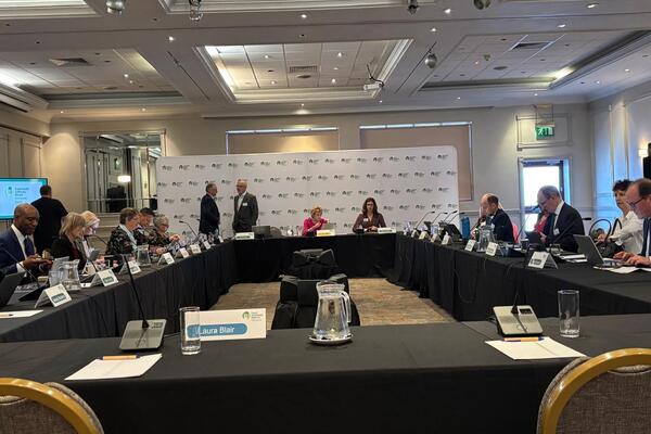 FSA Board meeting around a table with FSA branding behind in Swansea