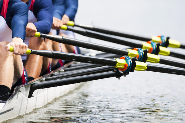 A group of people rowing in a race