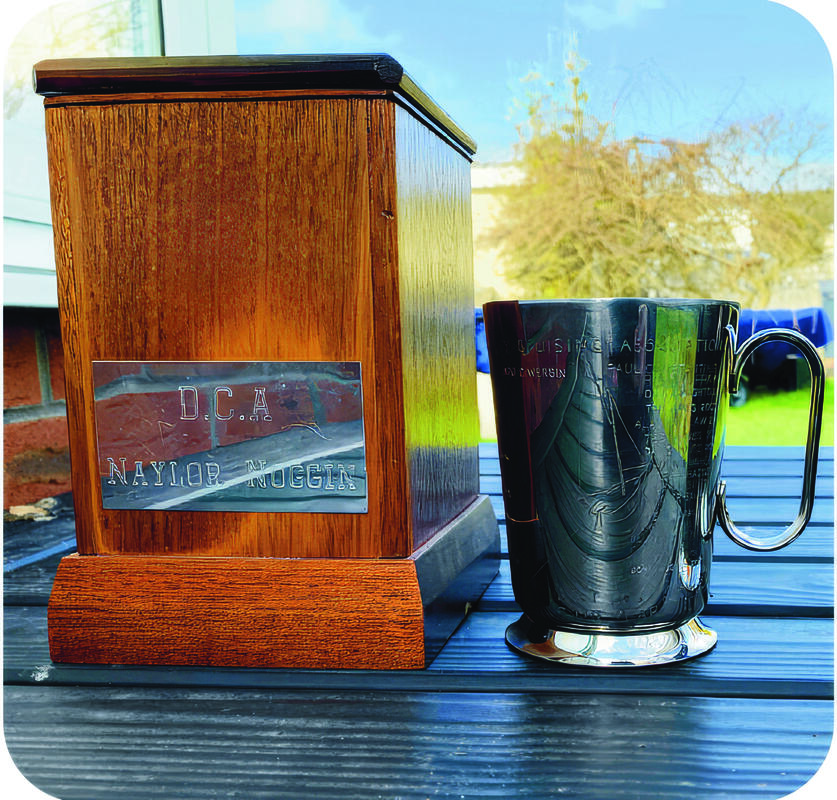 A photo of the Naylor Noggin cup next to its pedestal.