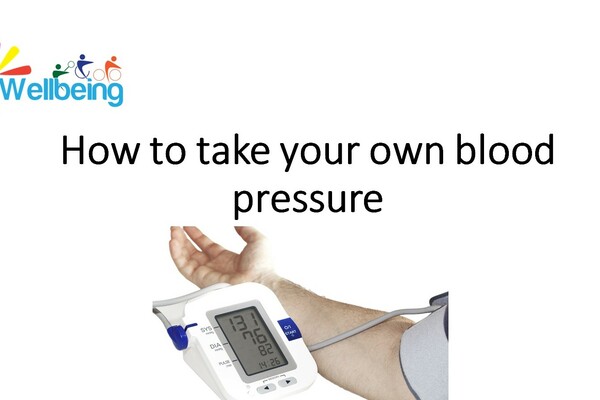 This image shows someone's arm, with a strap around their bicep, which is connected to a blood pressure monitor.
