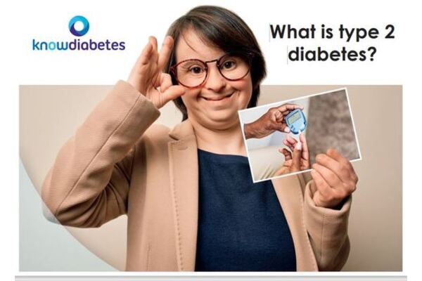 The image shows someone signing OK with their right hand up, whilst holding a picture of another person reading a blood glucose monitor system.