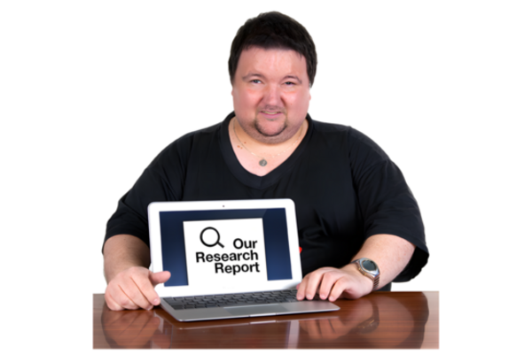 The picture shows a man showing the screen of his laptop with the word Our Research Report showing on his screen.