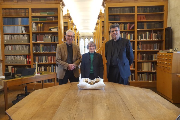 The Canon Chancellor, Anne Dutton Librarian, and the Dean with the Bible in the Cathedral's 15th-century library.