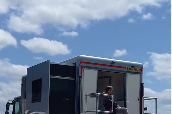 View of the horsebox against a blue sky with clouds