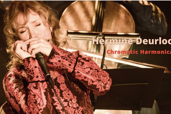 Photo of Hermine Deurloo playing harmonica