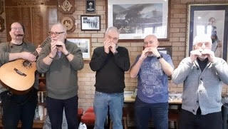 Aidan and his students practicing harmonica