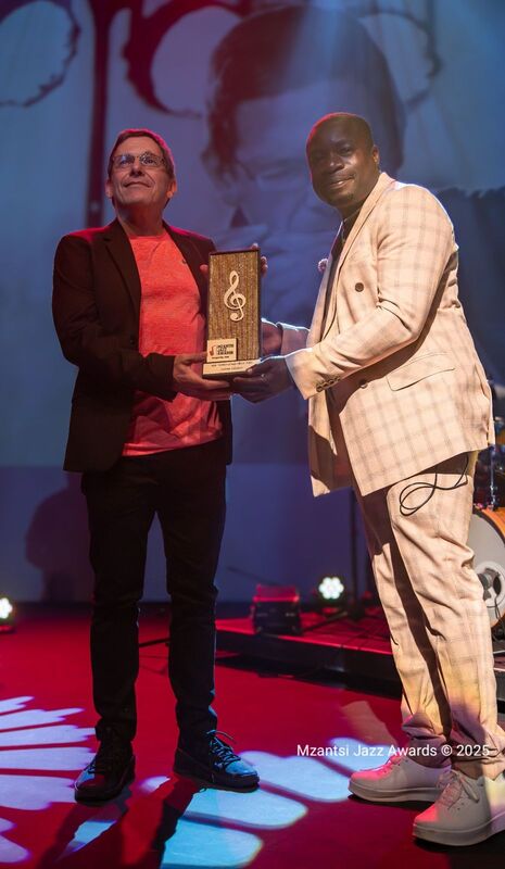 Adam receiving the award