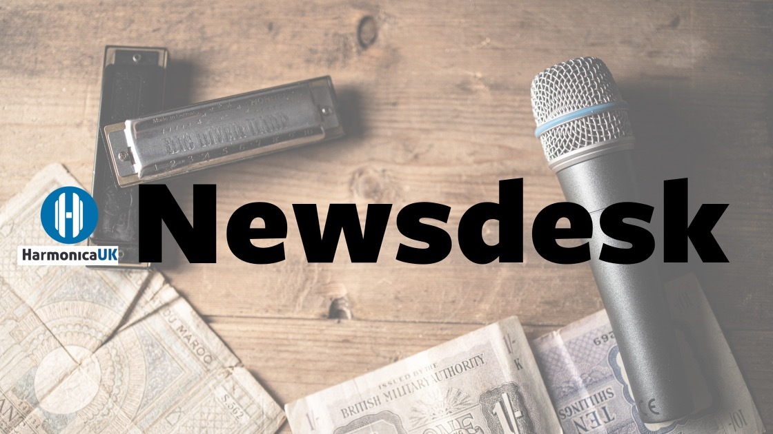 Newsdesk header - harmonica and microphone on a table