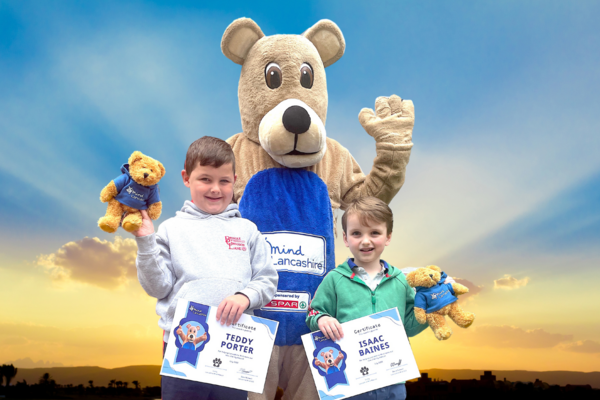 Mascot with children who won the competition