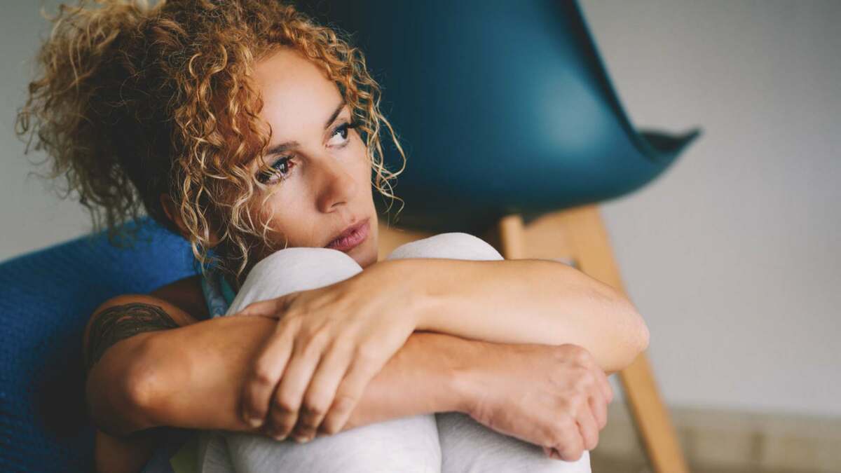 Woman at home worrying about money