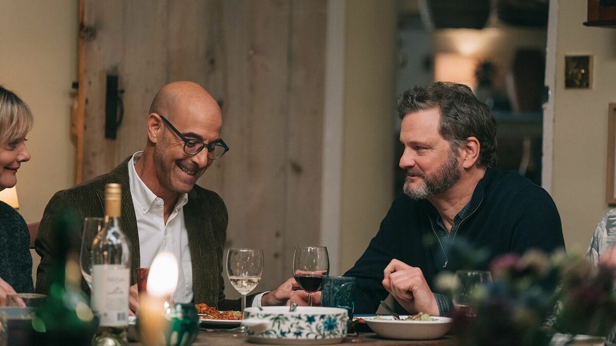 Stanley Tucci and Colin Firth around a table in Supernova film