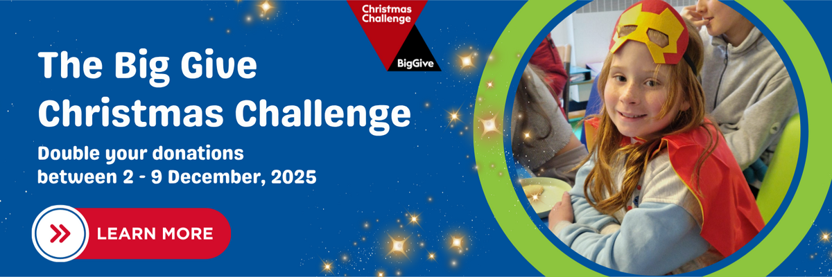 The Big Give Christmas Challenge.” The text reads: “Double your donations between 2 - 9 December, 2025.” On the right, there is a smiling child wearing a red and yellow superhero mask and cape. The background is blue with stars, and there’s a red button that says “Learn More.