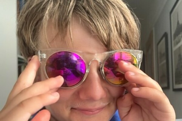 Sam, a young service user wearing a pair of sunglasses 