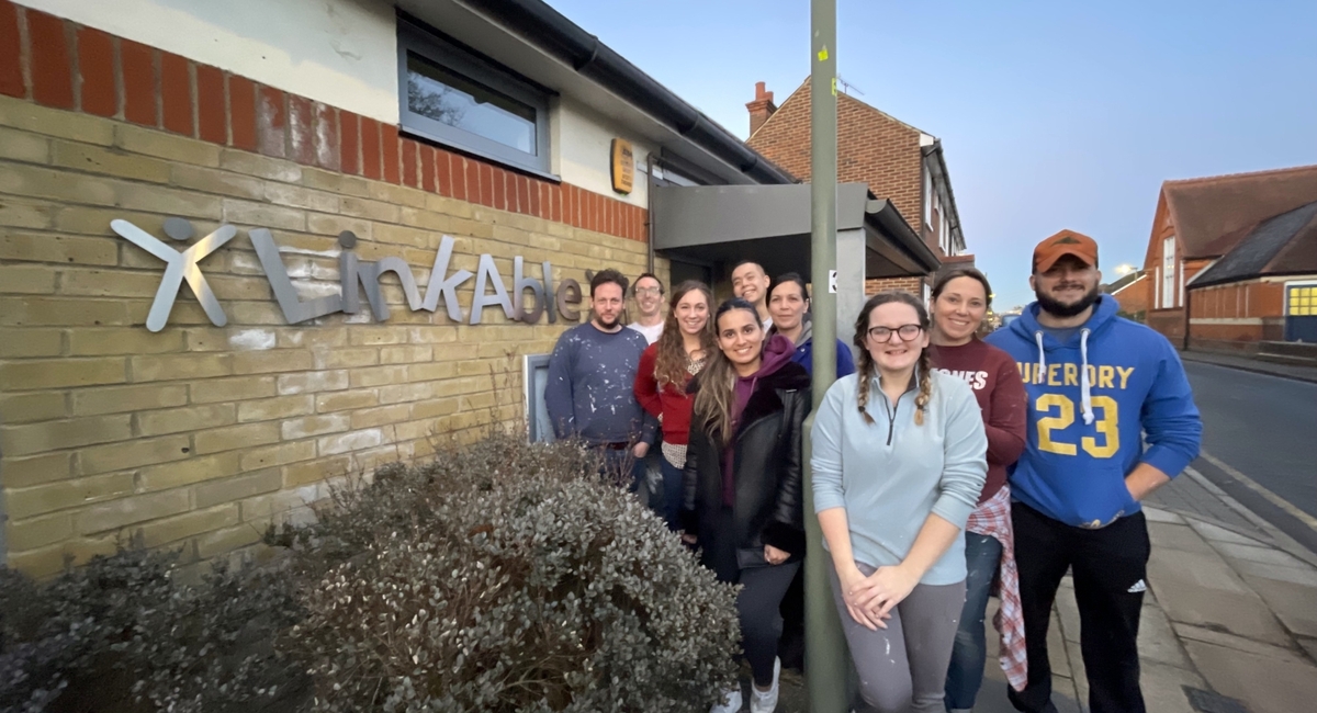 A group of volunteers stand outside the LinkAble building