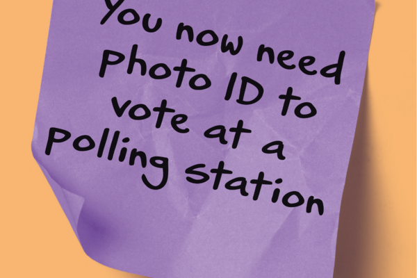 Purple post it note which says 'you now need photo ID to vote at a polling station' 