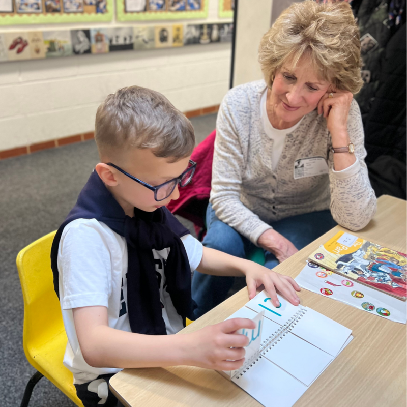 Volunteer reading with child in partner school Learn to Love to Read